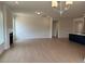 Open living room showcasing a fireplace and flows into a modern kitchen area at 243 Kissington Way, Benson, NC 27504