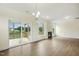 Bright living room with wood floors, fireplace, and sliding glass doors leading to the porch at 243 Kissington Way, Benson, NC 27504
