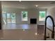 Open-concept living area with fireplace, hardwood floors, and sliding door to the outdoors at 243 Kissington Way, Benson, NC 27504