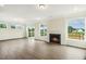 Open concept living room with a fireplace and sliding doors that provide scenic views at 243 Kissington Way, Benson, NC 27504