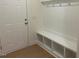 Mudroom features a door to the exterior and a built-in bench with storage and coat hooks at 243 Kissington Way, Benson, NC 27504