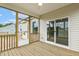 Cozy screened-in porch with wooden floors, adjacent to a glass sliding door leading indoors at 243 Kissington Way, Benson, NC 27504
