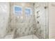Tiled shower with built-in bench, niche, and dual windows bringing in natural light at 243 Kissington Way, Benson, NC 27504
