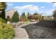Spacious backyard with stone patio, pergola, dining area and lush greenery, ideal for entertaining at 2526 Snowdrop Ct, Apex, NC 27502
