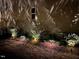 Backyard featuring professional landscape lighting to illuminate the house and landscaping at 2526 Snowdrop Ct, Apex, NC 27502