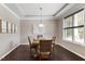 Cozy dining room features hardwood floors, a tray ceiling, a modern light fixture, and a large window at 2526 Snowdrop Ct, Apex, NC 27502
