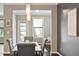 Elegant dining room with stylish lighting, dark wood floors and a view into the adjoining living space at 2526 Snowdrop Ct, Apex, NC 27502