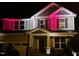 Charming two-story home with covered porch and well-maintained landscaping, illuminated by decorative lights at 2526 Snowdrop Ct, Apex, NC 27502