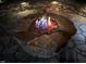 Illuminated stone fire pit with decorative glass is perfect for outdoor entertaining at 2526 Snowdrop Ct, Apex, NC 27502