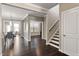 Open concept foyer features hardwood floors, an adjacent dining room, and a staircase to the second floor at 2526 Snowdrop Ct, Apex, NC 27502