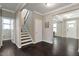 Entryway with hardwood floors, a staircase to the upper level, and access to a dining room at 2526 Snowdrop Ct, Apex, NC 27502