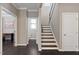 Upstairs hallway features hardwood floors, a staircase to the upper level, and access to a bathroom at 2526 Snowdrop Ct, Apex, NC 27502