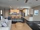 Modern living room open to kitchen featuring granite counters, stainless appliances and island seating at 2526 Snowdrop Ct, Apex, NC 27502
