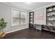 Bright office with hardwood floors, lots of natural light from a large window, and built-in bookshelves at 2526 Snowdrop Ct, Apex, NC 27502