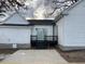 Exterior shot of the backyard with a dark porch, concrete patio and sliding glass doors at 334 E Andrews Ave, Henderson, NC 27536