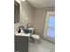 A cozy bathroom with a modern sink, toilet and small window that provides natural light at 334 E Andrews Ave, Henderson, NC 27536