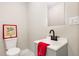 Cozy bathroom with updated sink, vanity, toilet, mirror and light fixtures at 334 E Andrews Ave, Henderson, NC 27536