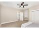 Large bedroom with neutral paint, carpeting, ceiling fan, and connecting bathroom at 334 E Andrews Ave, Henderson, NC 27536