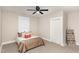 Bright bedroom with neutral paint, carpet, ceiling fan, closet, and ample natural light at 334 E Andrews Ave, Henderson, NC 27536