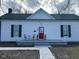 Charming home with a bright red front door and a cozy porch area at 334 E Andrews Ave, Henderson, NC 27536