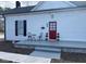 Charming home with a bright red front door and a cozy porch area at 334 E Andrews Ave, Henderson, NC 27536