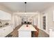 Open concept kitchen with island featuring granite counters and seating for entertaining at 334 E Andrews Ave, Henderson, NC 27536