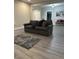 Spacious living room with hardwood floors and comfortable seating at 334 E Andrews Ave, Henderson, NC 27536