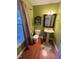 Charming powder room with pedestal sink and wood flooring at 35 Pine Water Way, Spring Lake, NC 28390