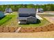 Back exterior of a home featuring a covered patio and beautifully landscaped yard at 367 Duncan Creek Rd # 129, Lillington, NC 27546