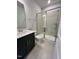Modern bathroom features walk-in shower with glass door, tiled floor, and vanity at 367 Duncan Creek Rd # 129, Lillington, NC 27546