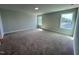 Bedroom with neutral walls, carpet, white trim, and two windows overlooking the outdoors at 367 Duncan Creek Rd # 129, Lillington, NC 27546