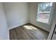 Bedroom with wood flooring and a bright window offering outside views at 367 Duncan Creek Rd # 129, Lillington, NC 27546