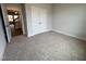 Carpeted bedroom with double door closet and open doorway to hall and stairs at 367 Duncan Creek Rd # 129, Lillington, NC 27546