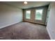 This bedroom has neutral paint, two windows and soft carpet for a cozy and inviting space at 367 Duncan Creek Rd # 129, Lillington, NC 27546