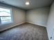 This bedroom has neutral paint, one window and soft carpet for a cozy and inviting space at 367 Duncan Creek Rd # 129, Lillington, NC 27546