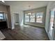 Bright dining room with decorative lighting, wood floors, and large windows overlooking backyard at 367 Duncan Creek Rd # 129, Lillington, NC 27546