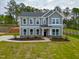 Charming two-story home with a well-manicured lawn and beautiful landscaping at 367 Duncan Creek Rd # 129, Lillington, NC 27546