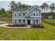 Classic gray two-story home with bright white-trim windows, complemented by a lush green lawn at 367 Duncan Creek Rd # 129, Lillington, NC 27546