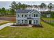 Charming gray two-story home featuring a well-manicured lawn, complemented by classic white-trim windows at 367 Duncan Creek Rd # 129, Lillington, NC 27546