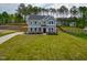 Two-story home boasts manicured lawn, long driveway and classic architectural details at 367 Duncan Creek Rd # 129, Lillington, NC 27546