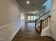 Foyer with hardwood flooring, staircase with white railing, and view into the living area at 367 Duncan Creek Rd # 129, Lillington, NC 27546