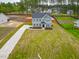 Expansive front yard featuring a long driveway and lush green lawn at 367 Duncan Creek Rd # 129, Lillington, NC 27546