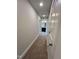 Hallway with carpet, neutral paint, leading to the ensuite bathroom with a dual vanity at 367 Duncan Creek Rd # 129, Lillington, NC 27546