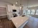 Contemporary kitchen with a large island, white cabinets, and stainless steel appliances at 367 Duncan Creek Rd # 129, Lillington, NC 27546