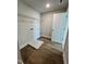 Laundry room with wood floors, shelving, utility connections, and a white door at 367 Duncan Creek Rd # 129, Lillington, NC 27546
