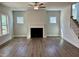 Living room with decorative fireplace, wood floors, and several windows providing natural light at 367 Duncan Creek Rd # 129, Lillington, NC 27546