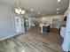 Open concept living area with wood flooring, staircase, and abundant natural light at 367 Duncan Creek Rd # 129, Lillington, NC 27546