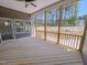 Screened in back porch with wood flooring and siding overlooking wooded backyard at 403 Duncan Creek Rd # 131, Lillington, NC 27546