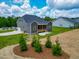 View of the backyard and the house showing a gray and brown color scheme at 403 Duncan Creek Rd # 131, Lillington, NC 27546