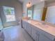 Bathroom featuring double sink vanity, quartz countertop, large mirror, and tile flooring at 403 Duncan Creek Rd # 131, Lillington, NC 27546